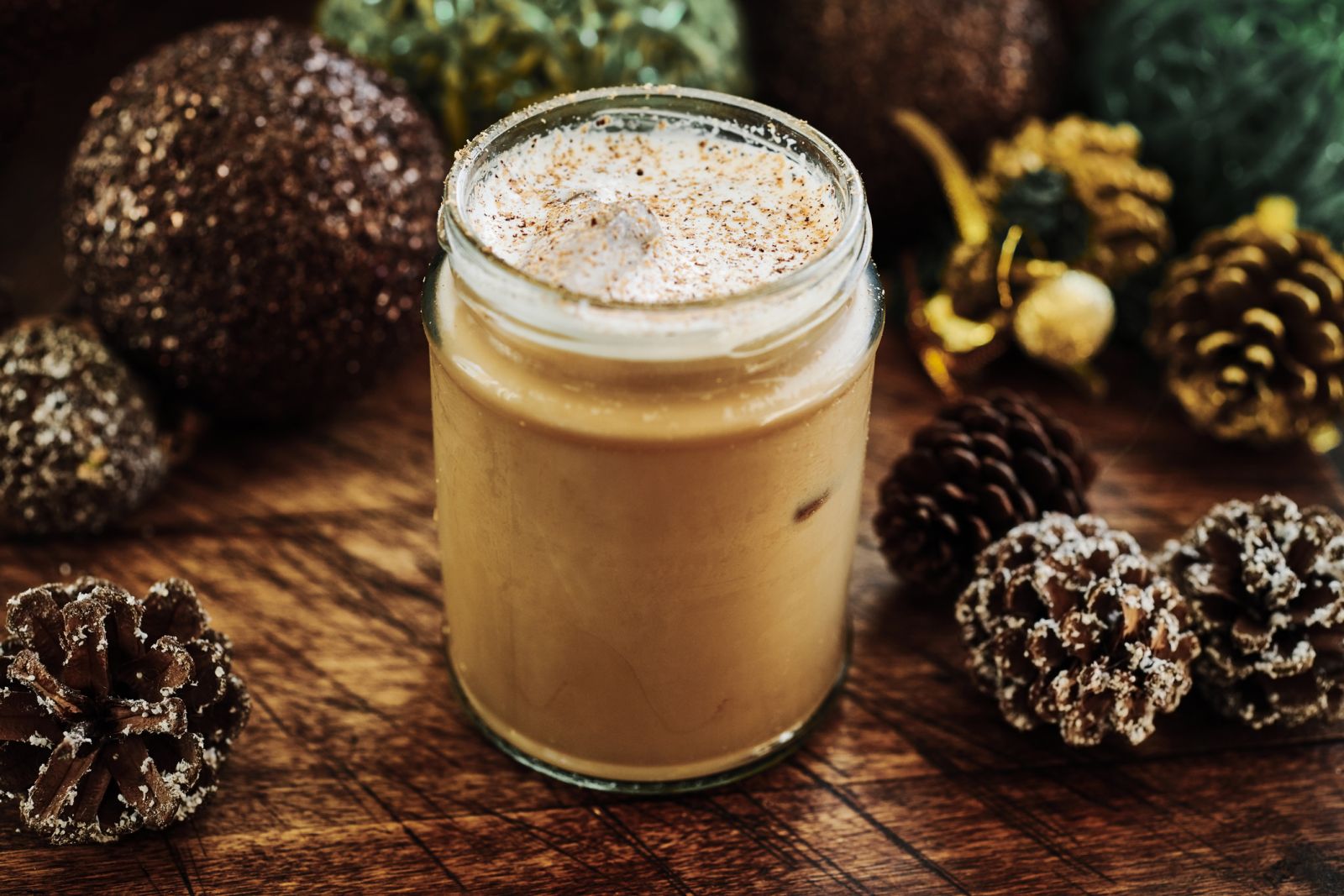 Latte in a Mason Jar surrounded by Pine Cones