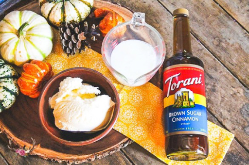 torani brown sugar cinnamon syrup with a bowl of ice cream and milk with some small pumpkins