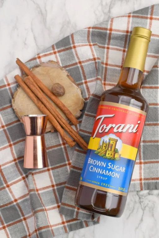 torani brown sugar cinnamon syrup with jigger and cinnamon sticks