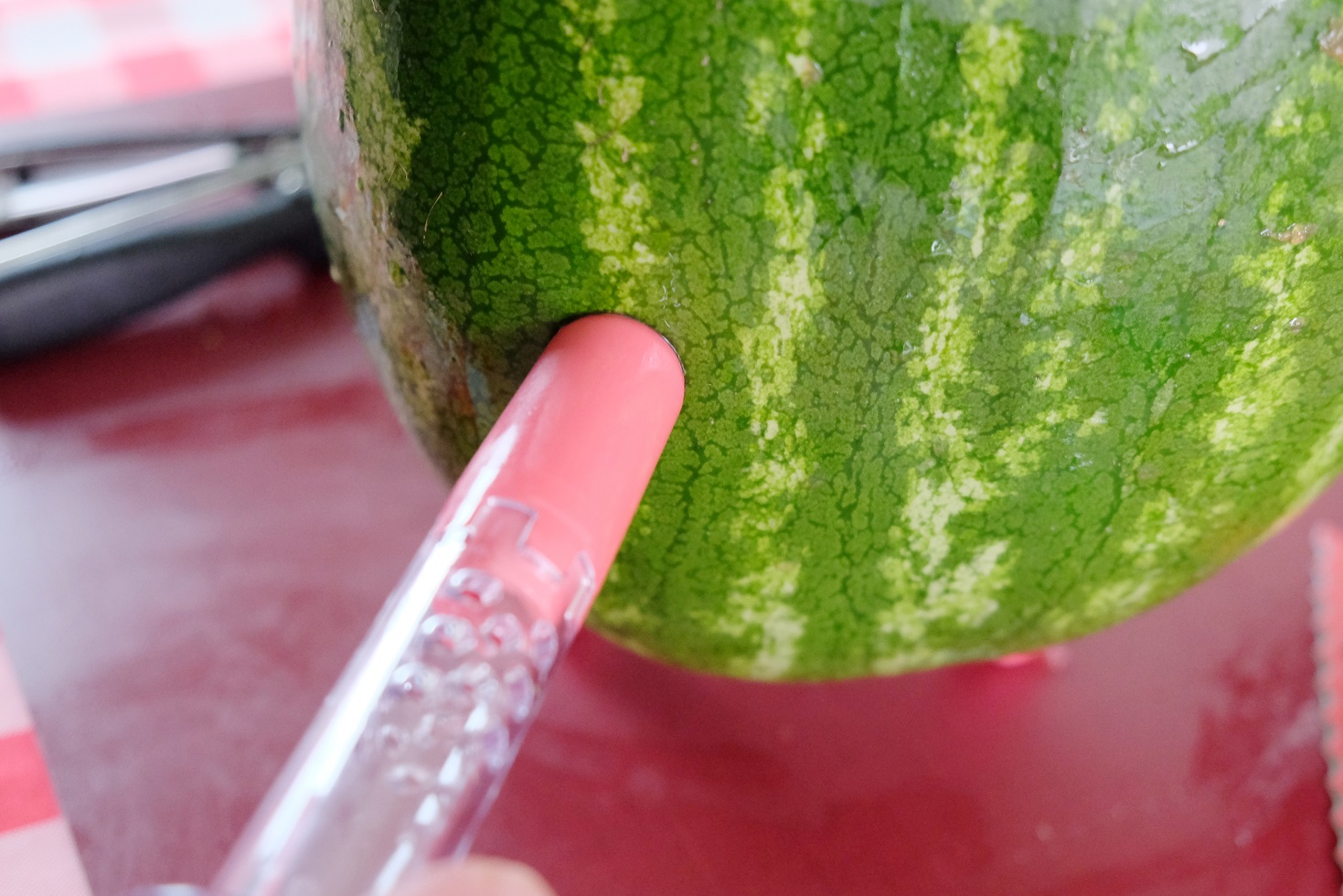 pushing tap into watermelon